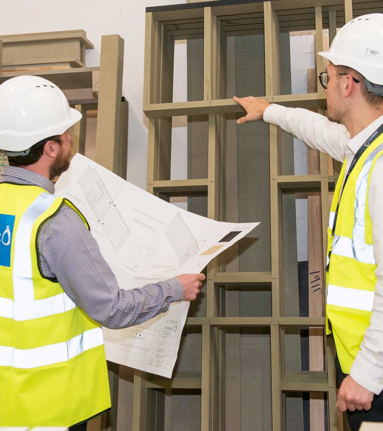 People Inspecting Wooden Frames